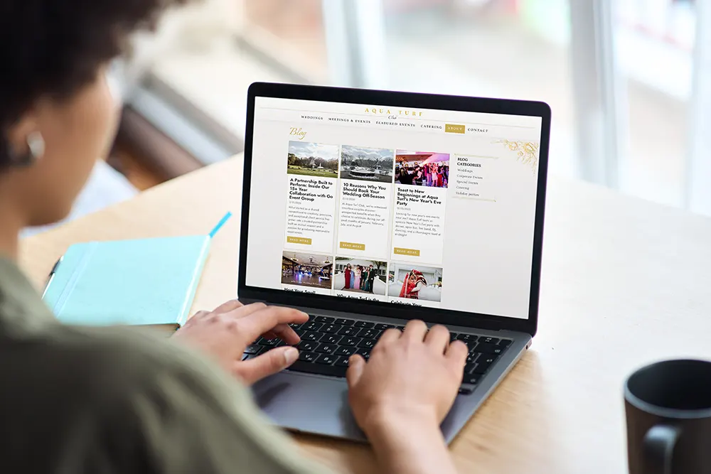 Person writing a blog article on their laptop to boost SEO through link building.