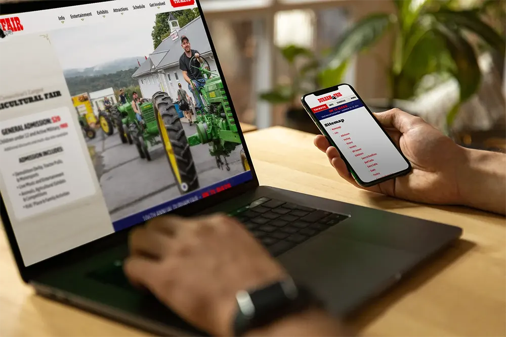 Person performing a technical SEO review on a laptop and smart phone.