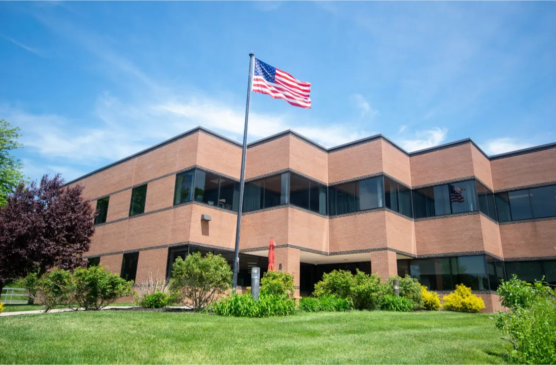 The WebSolutions building with an American flag waving in the wind.