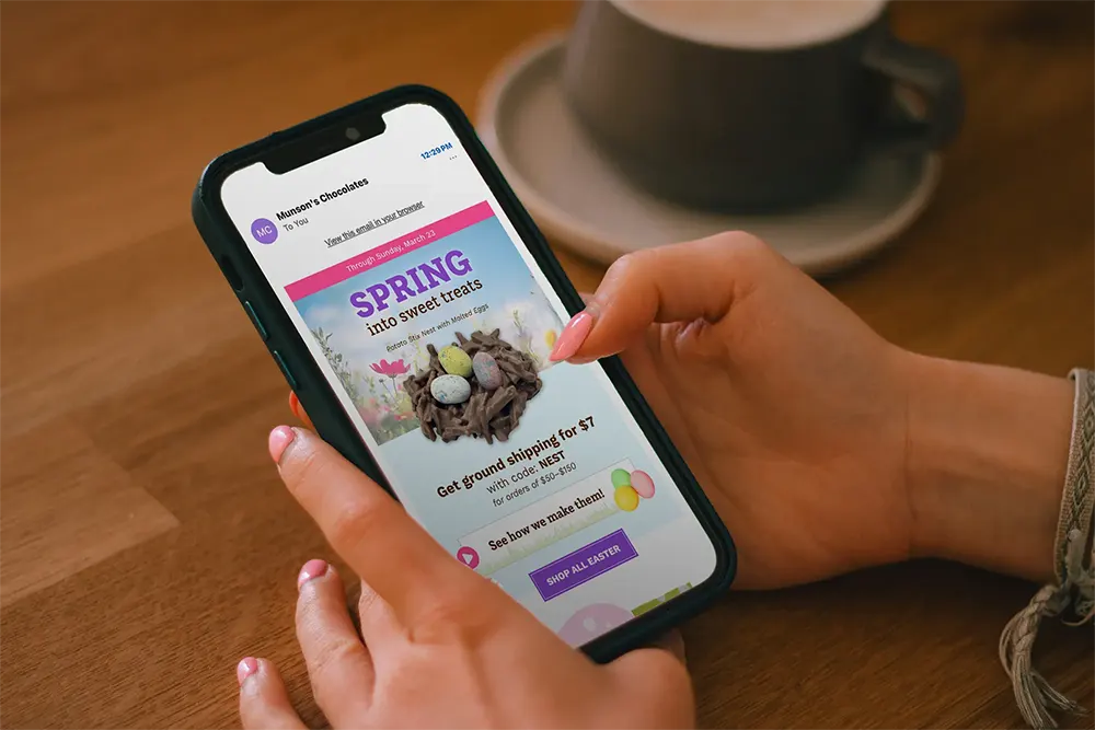 Person viewing a smartphone displaying a video-based marketing promotion.